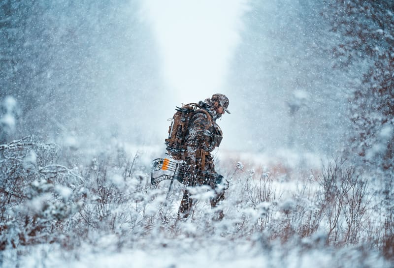 hunter walking through the snow